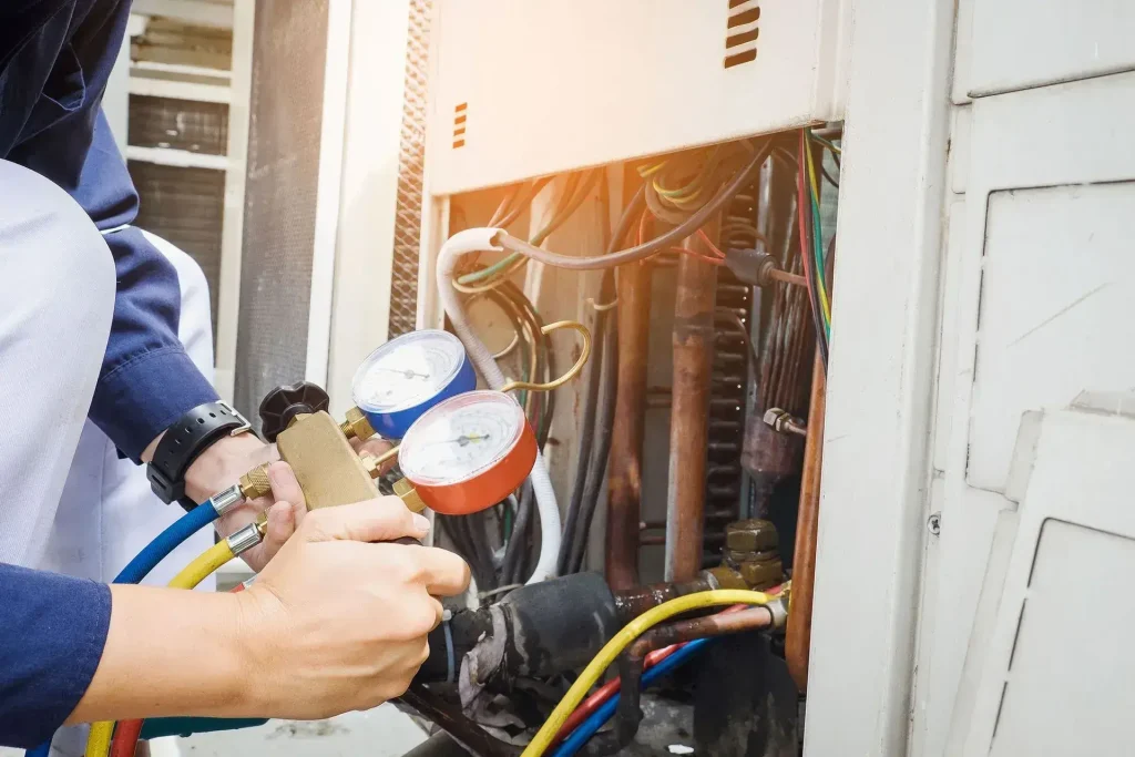 Technician servicing air conditioning unit