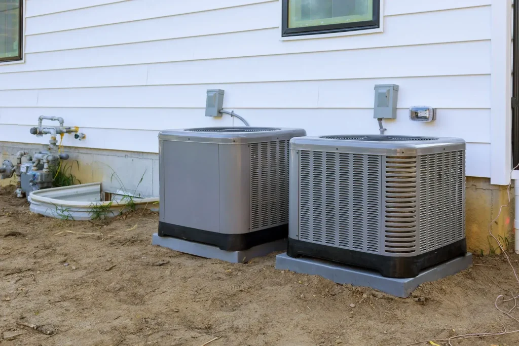 Two air conditioning units outside house