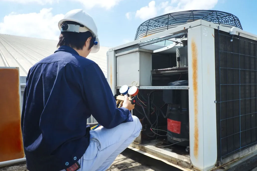 Technician servicing rooftop air conditioner.