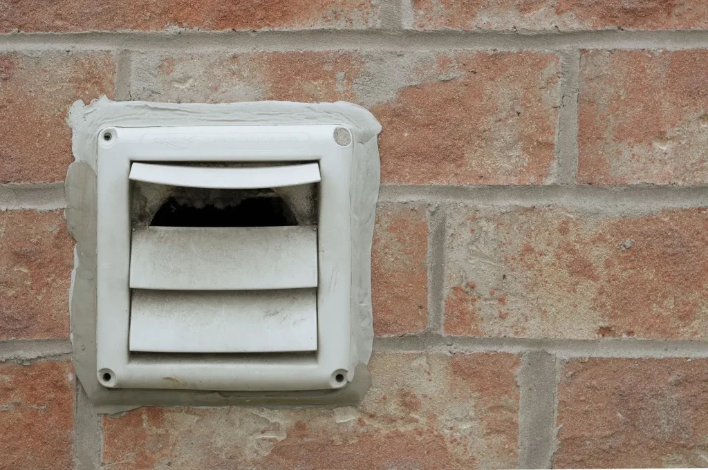 White vent on brick wall