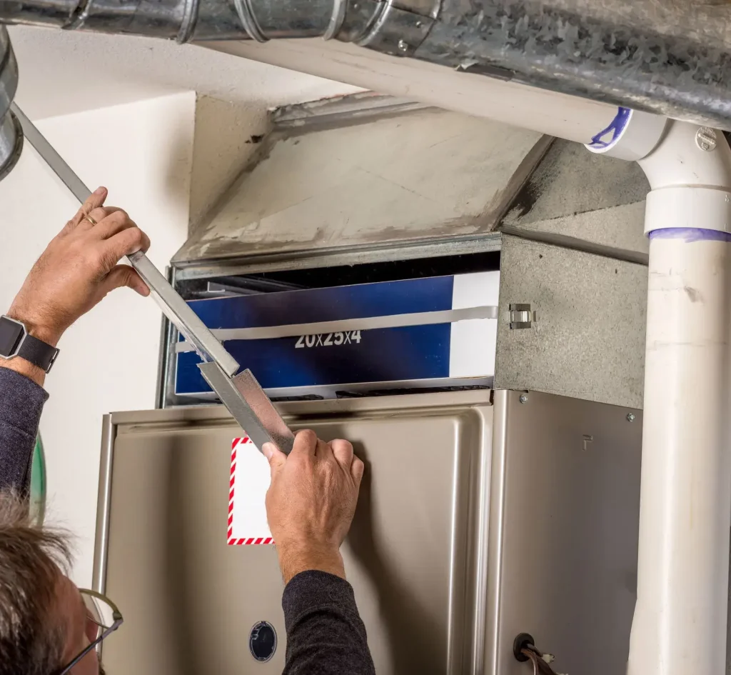 Person servicing a furnace unit