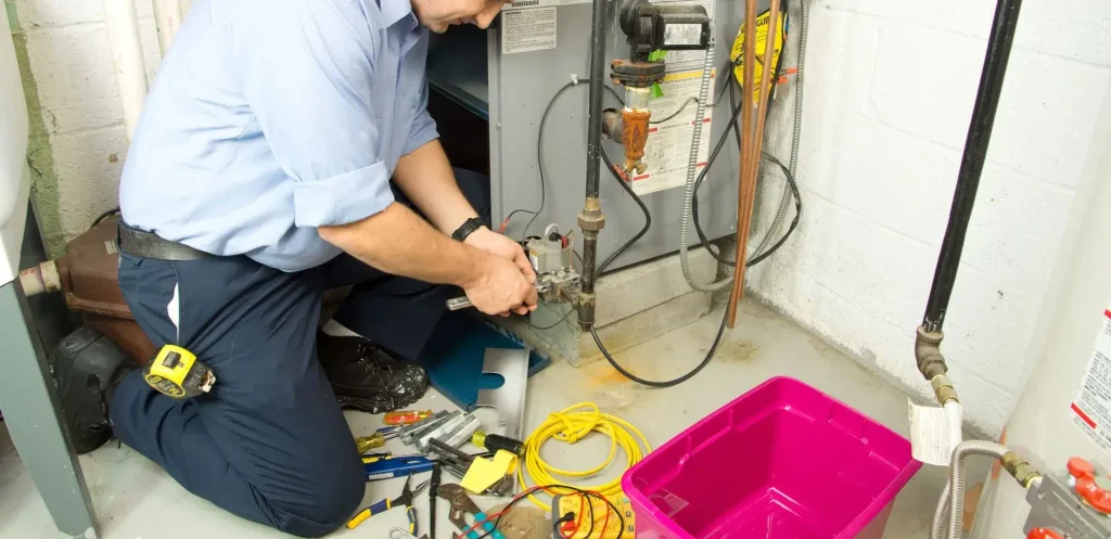 Technician repairing heating system components.