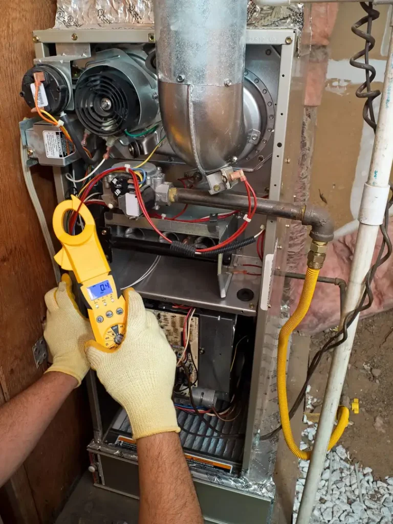 Person servicing a furnace unit