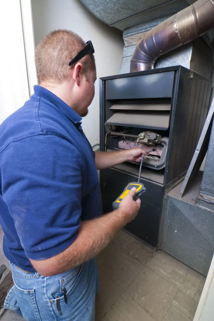 Technician inspecting a furnace unit.