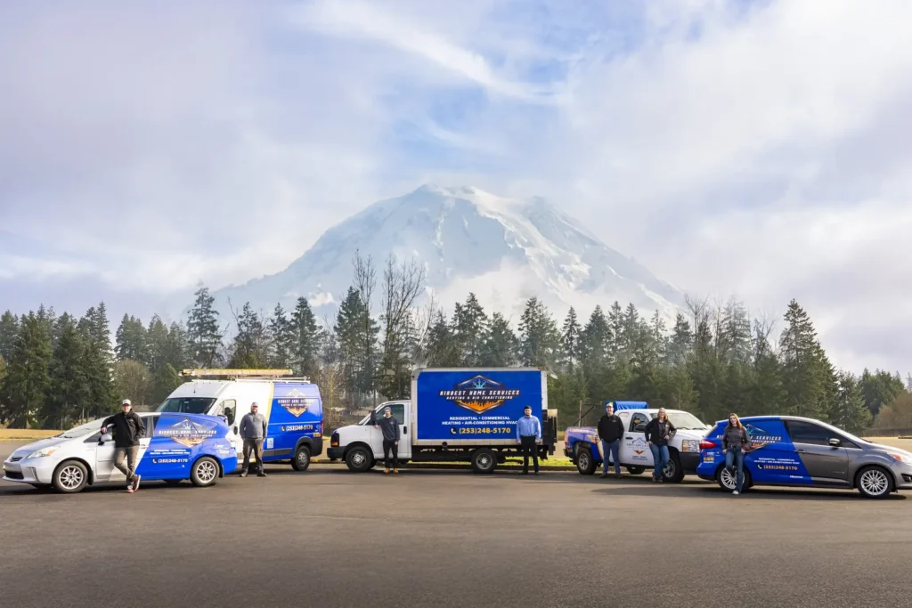 Vehicles parked with mountain backdrop.