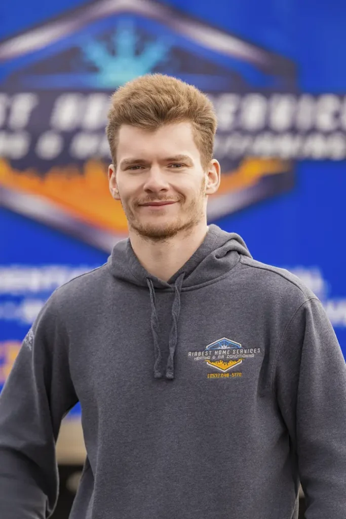 Person in gray hoodie, blue background